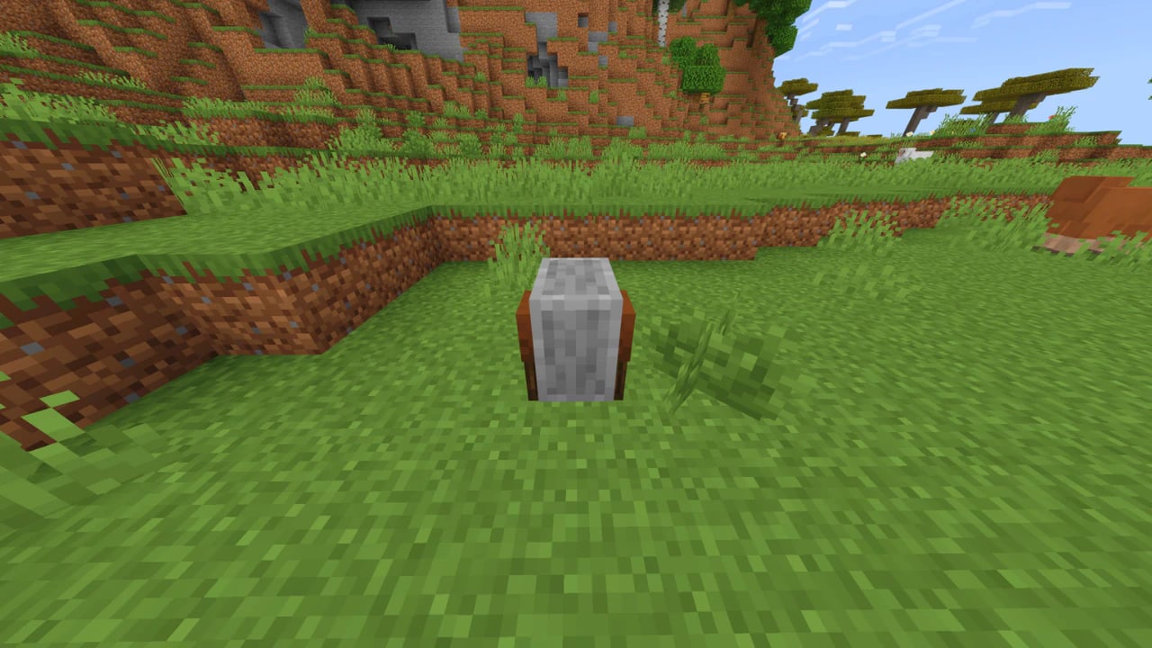 Minecraft grindstone block in a field for disenchanting items and repairing tools in high-performance gameplay.