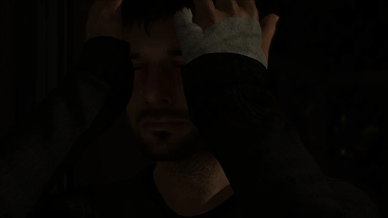 A man in deep shadow with his hands covering part of his face, one hand having a bandage or wrap around the wrist.