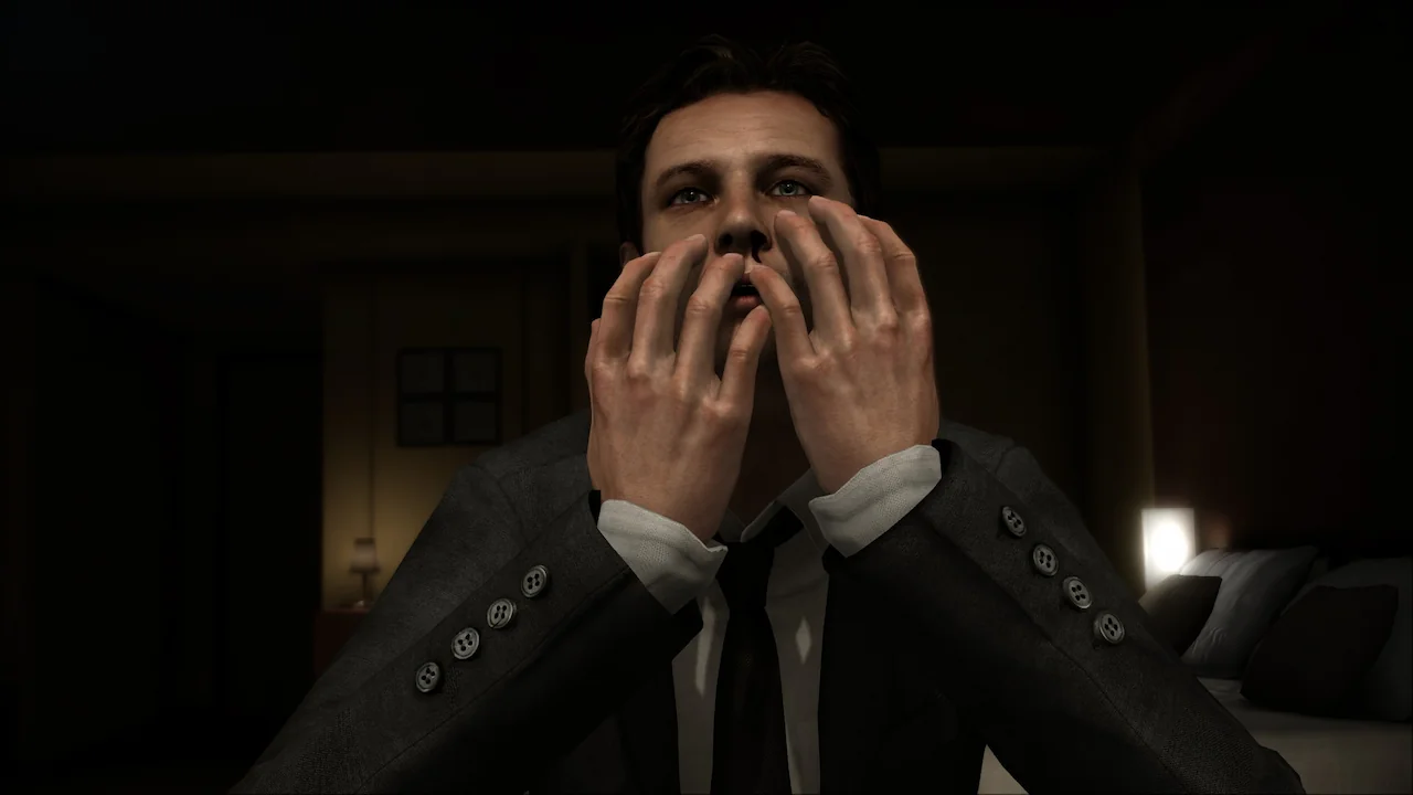 3D rendered video game character, Norman Jayden from Heavy Rain, showing distress with hands covering his face in a dimly lit room.