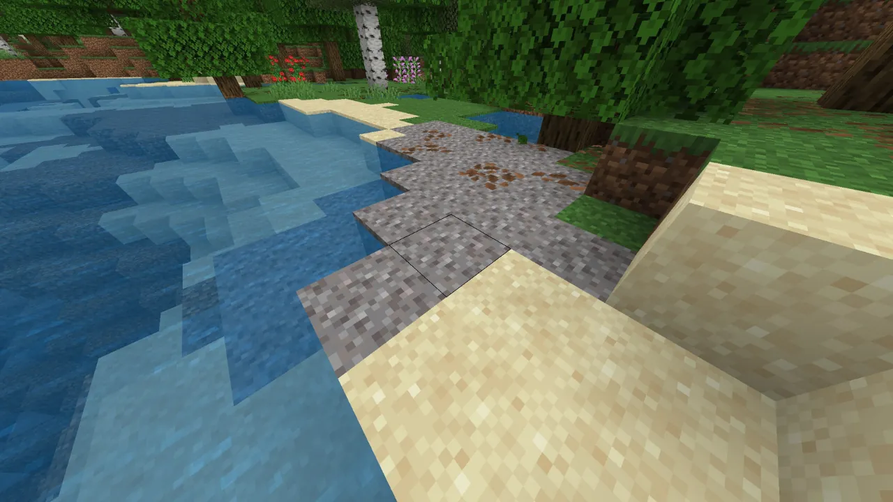 Minecraft screenshot featuring a river or lake with blue water, a sandy beach, coarse dirt, grass, and various trees.