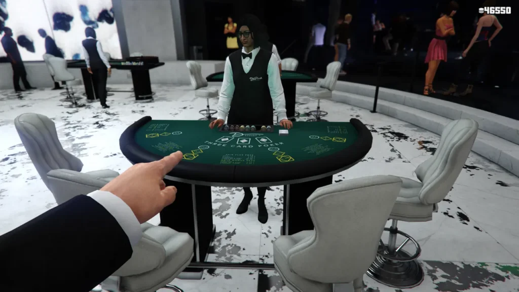 First-person view of a player's hand pointing at a 'Three Card Poker' table in a virtual casino, likely from Grand Theft Auto Online, with a dealer and other patrons in the background.