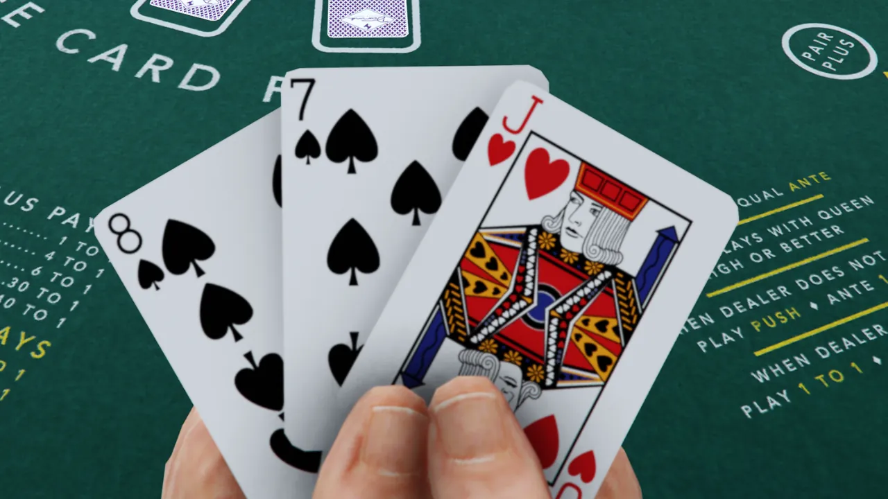 A player's hand holding an 8 of spades, 7 of spades, and Jack of hearts over a green casino table with game rules.