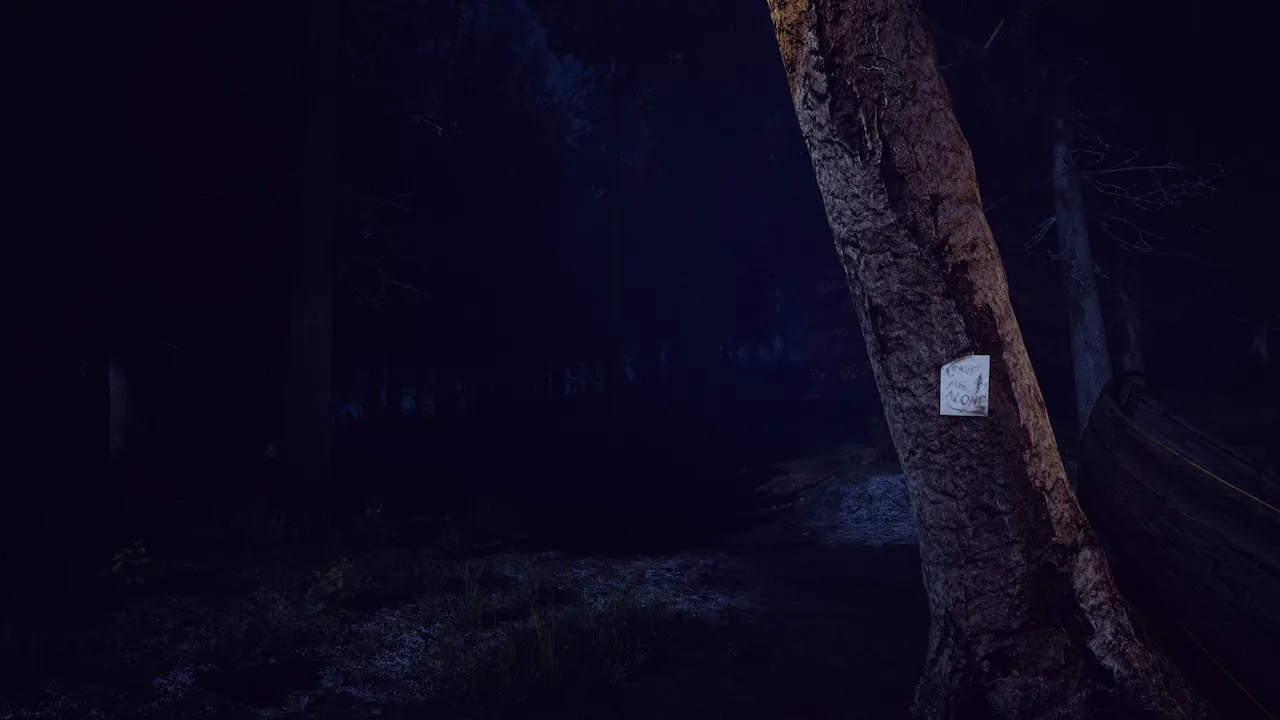 A dark, atmospheric video game forest scene at night. A tree in the foreground has a note pinned to it reading 'LEAVE ME ALONE'.