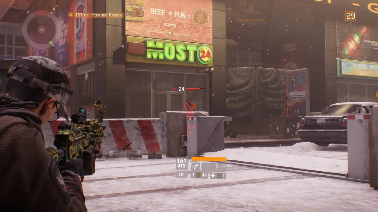 Third-person view of a player in Tom Clancy's The Division, aiming a camouflage LMG at an enemy in a snowy urban environment.