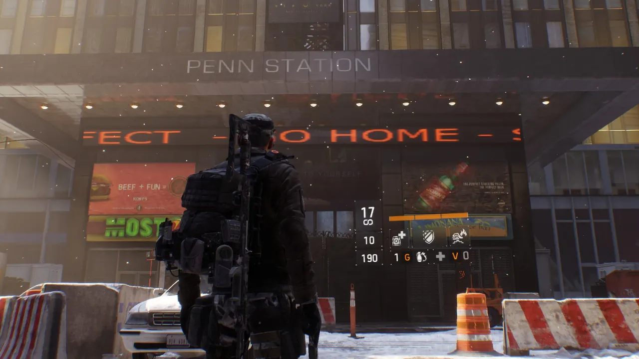 Tom Clancy's The Division agent in a snowy NYC street, facing the Penn Station building with visible HUD elements.